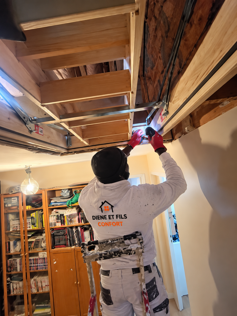Ouvrier Diene et Fils Comfort fixant les rails métalliques d'un faux plafond en plaques de plâtre en Île-de-France